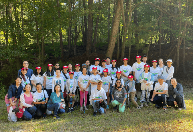 Volunteers gathered in the woods after the 2023 Lake Lanier Shore Sweep