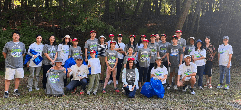 First Step volunteers gathered with filled cleanup bags at Lake Lanier
