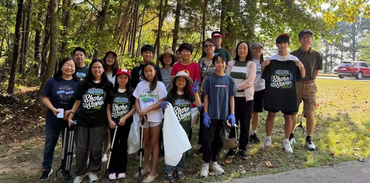 First Step volunteers posing with cleanup supplies at Lake Lanier
