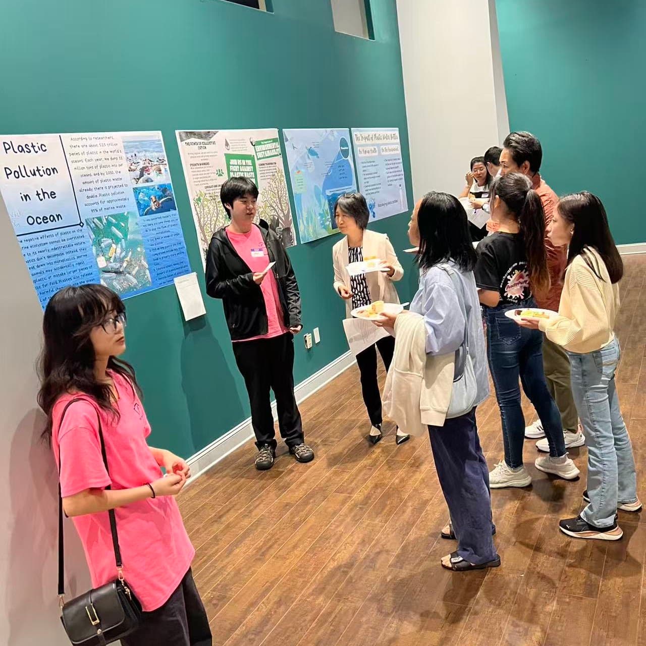 Students presenting First Step microplastics research posters