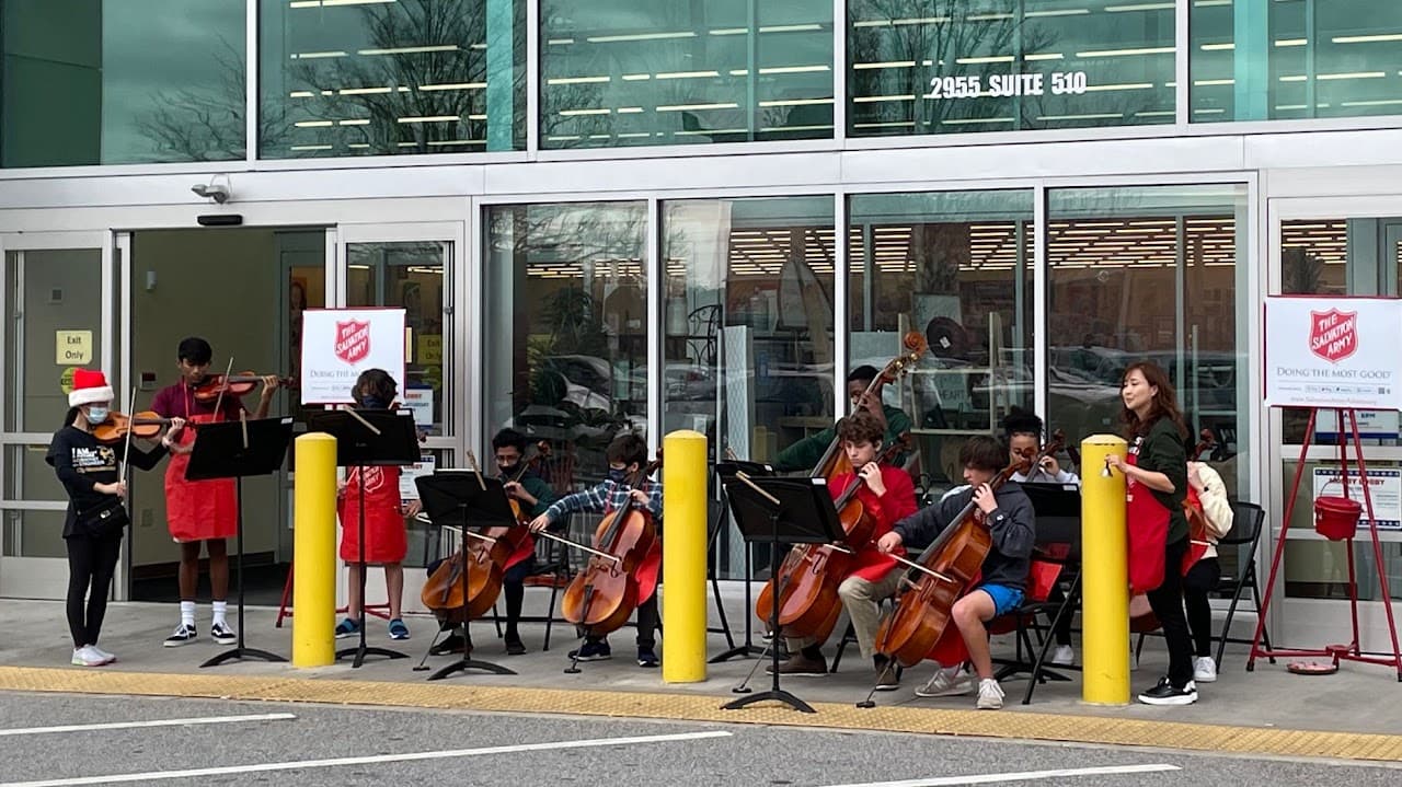Young musicians performing outside a store during Salvation Army bell ringing