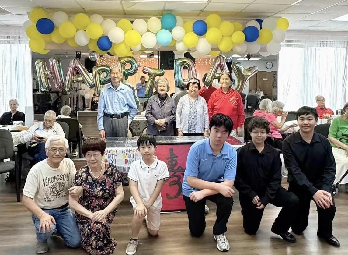 Young performers and residents gathered after a senior home performance