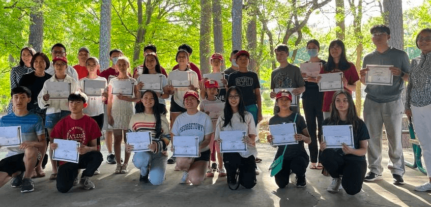 Young volunteers holding certificates at the Shine A Light ceremony