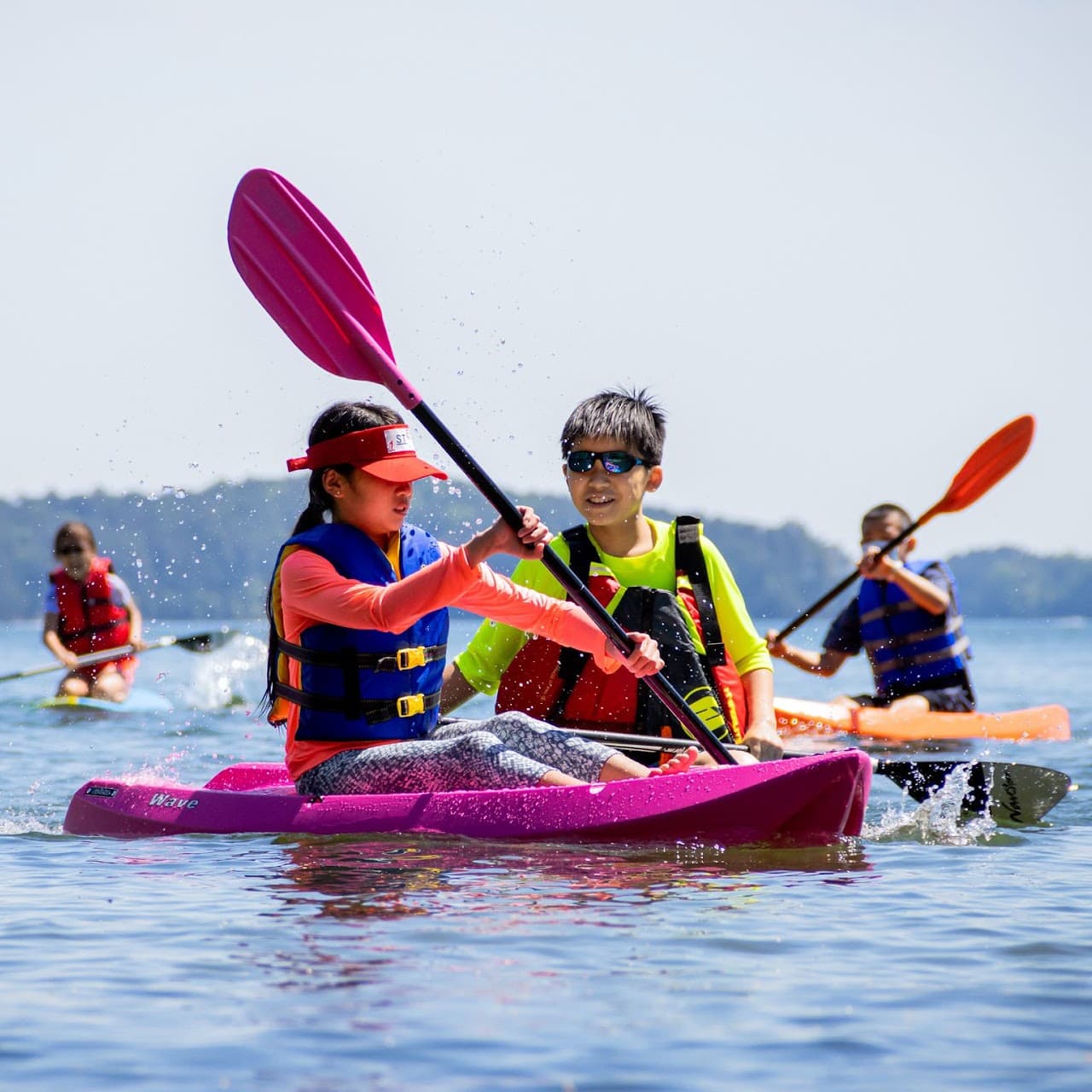 Two First Step members kayaking together on a lake